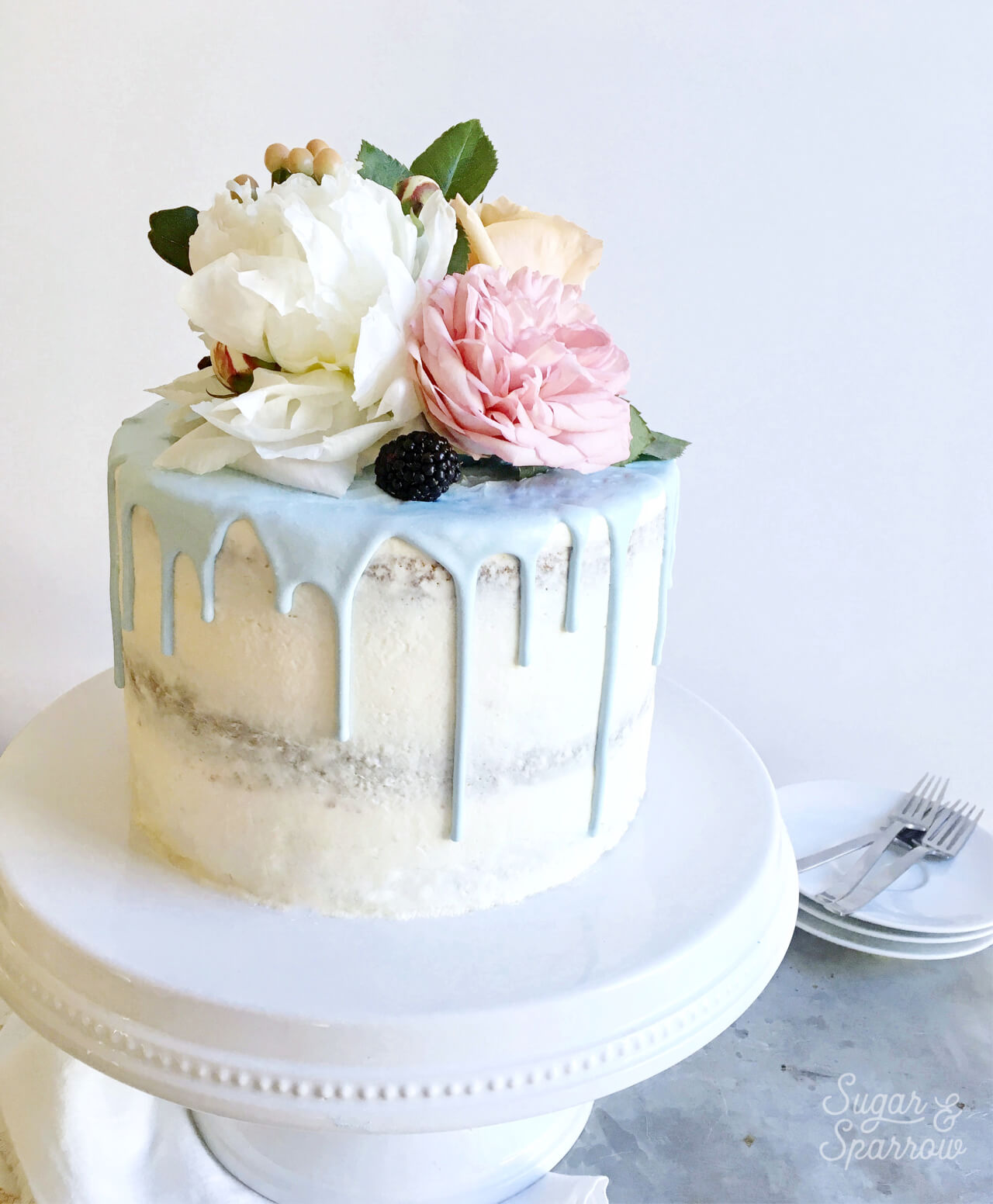 Sweet Petites - This semi naked cake dressed in some pretty florals! |  Facebook