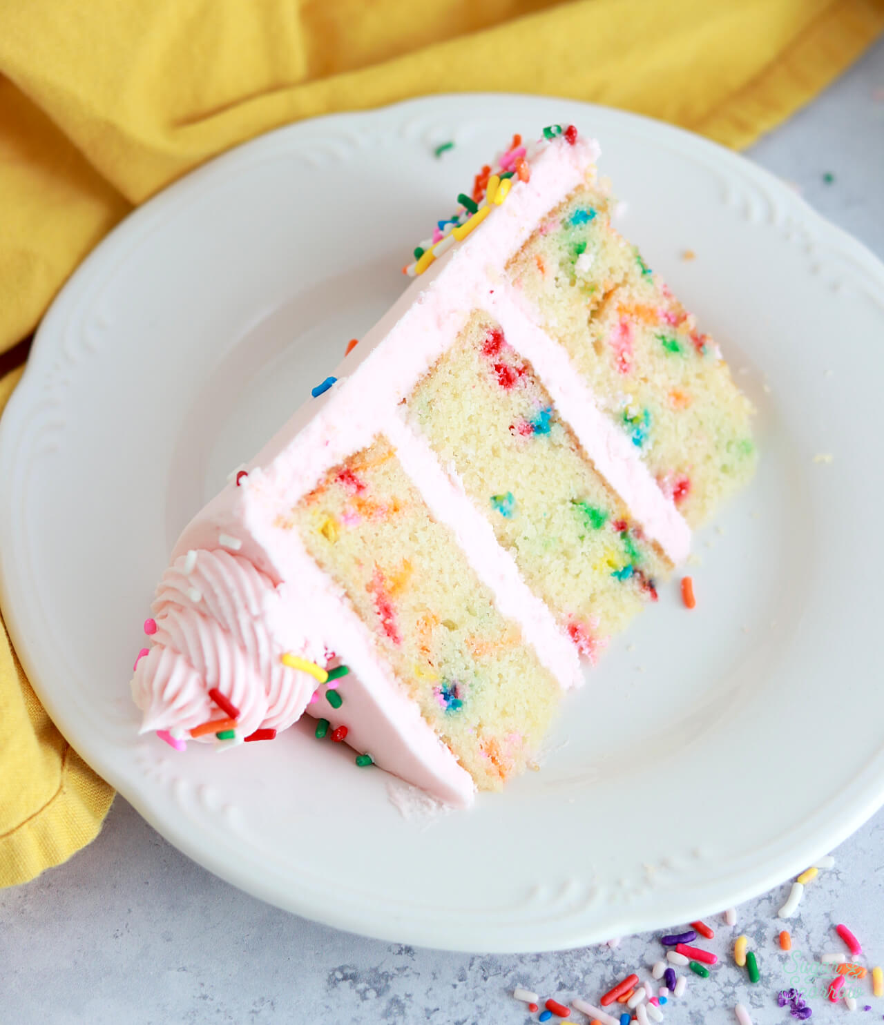 slice of homemade funfetti cake on a plate