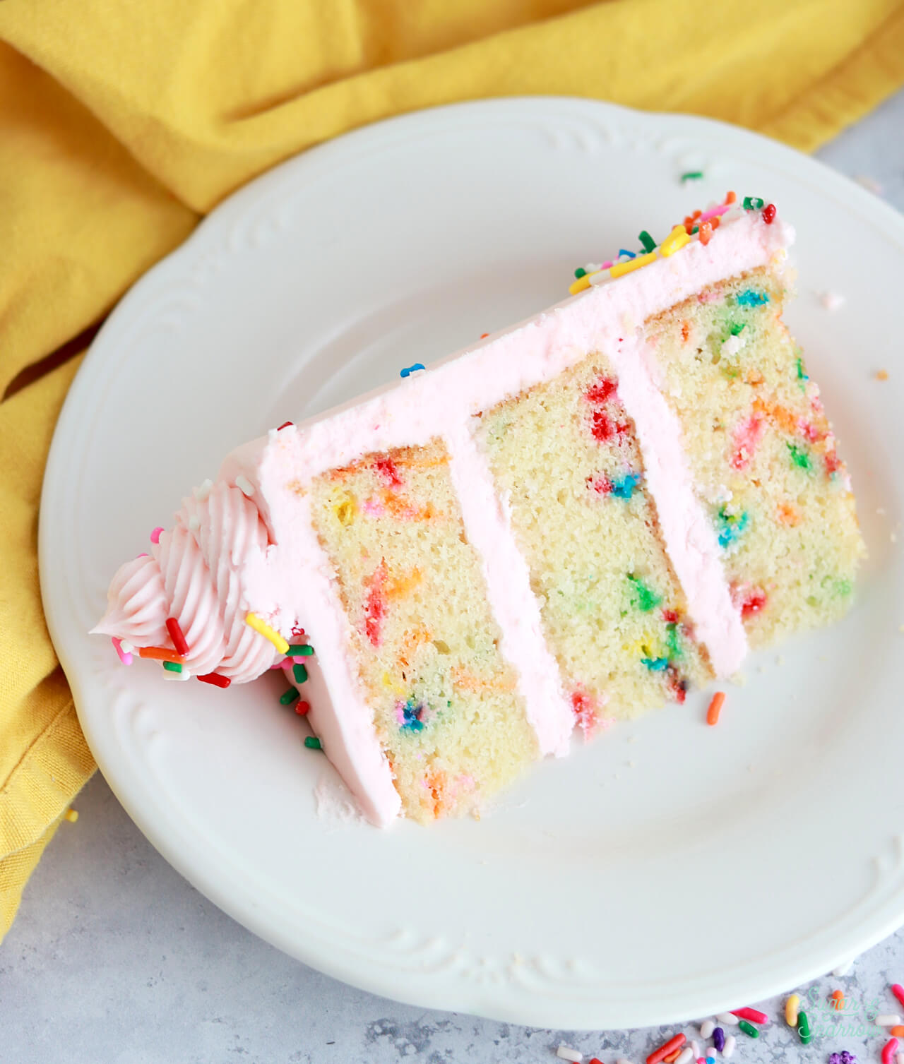 slice of funfetti cake on a white plate