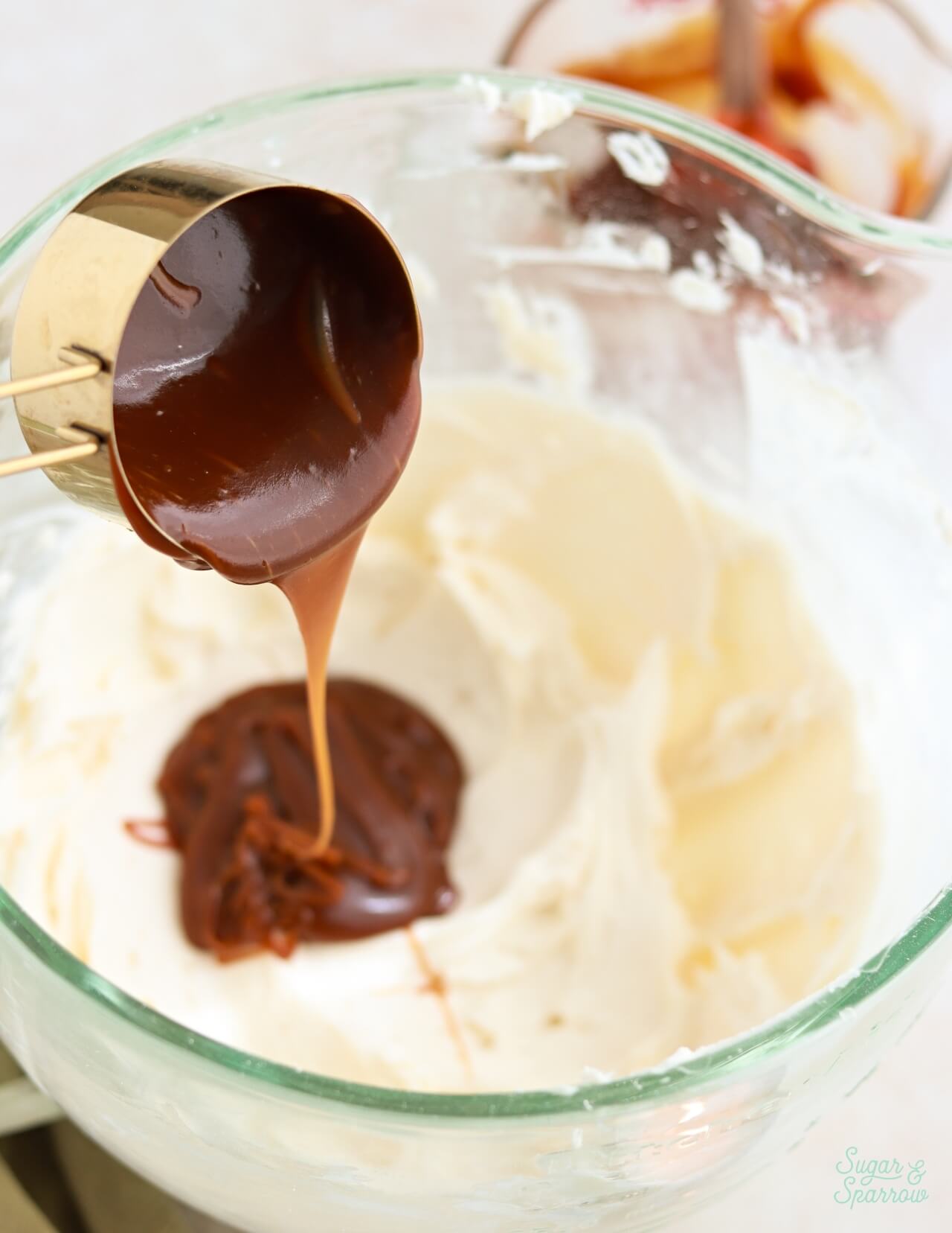 adding caramel sauce to buttercream frosting