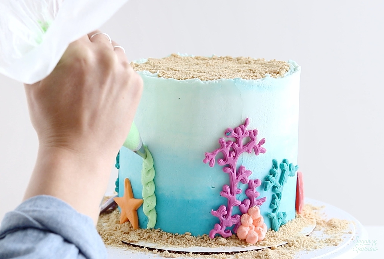 Under the sea kids birthday cake with edible sand, coral, …