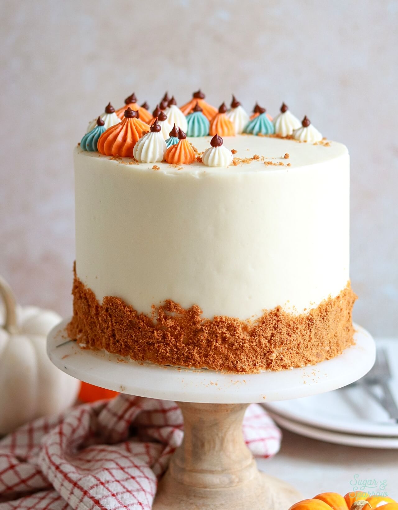perfect pumpkin layer cake with piped pumpkins on top