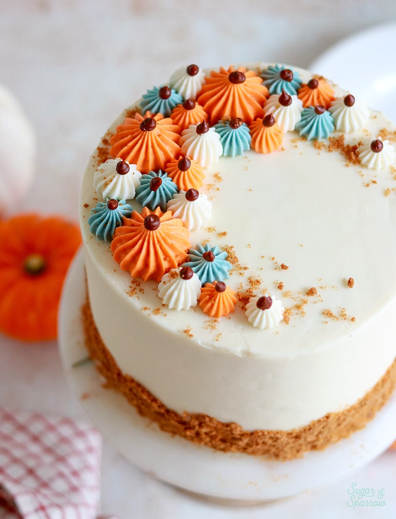 pumpkin layer cake with piped pumpkins on top