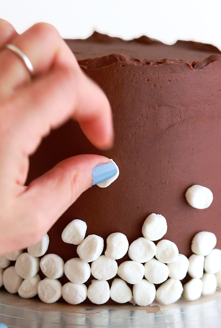 decorating a cake with marshmallows