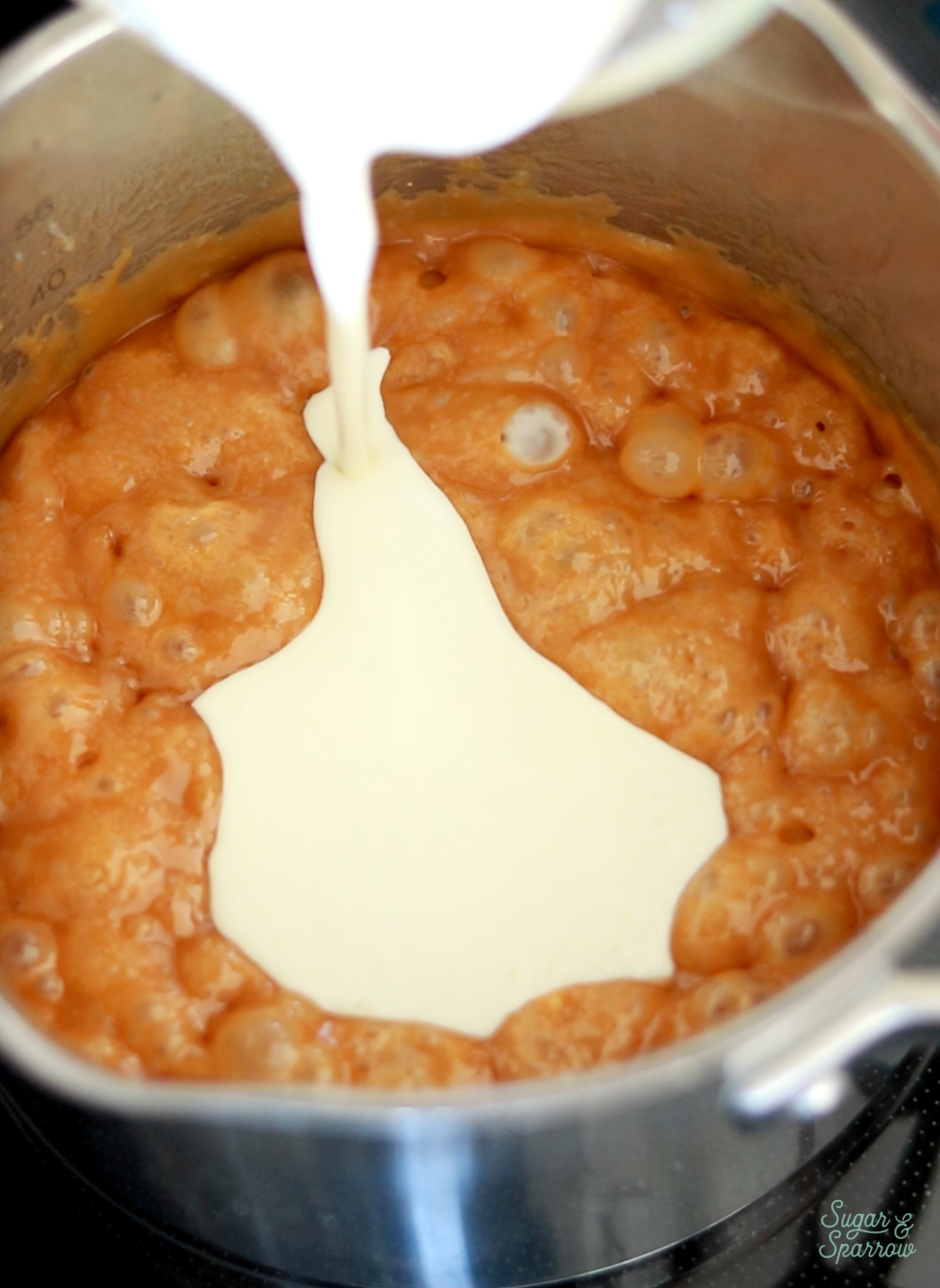 adding heavy whipping cream to salted caramel