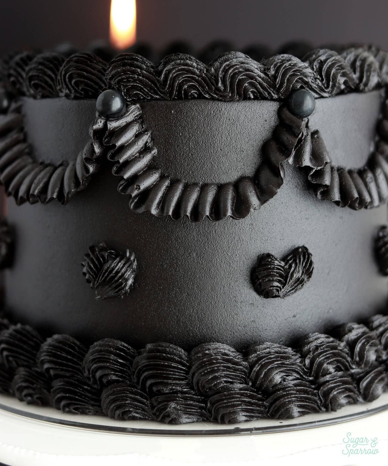 black buttercream cake with lambeth piping