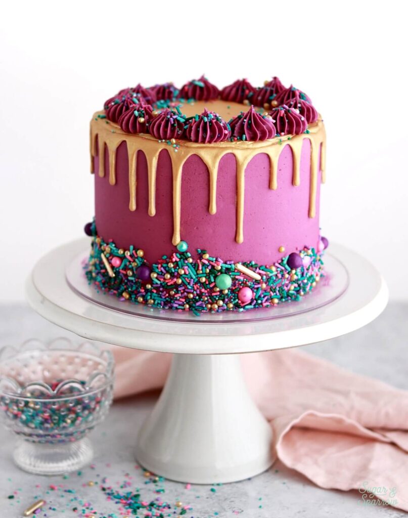 pink cake with gold drip