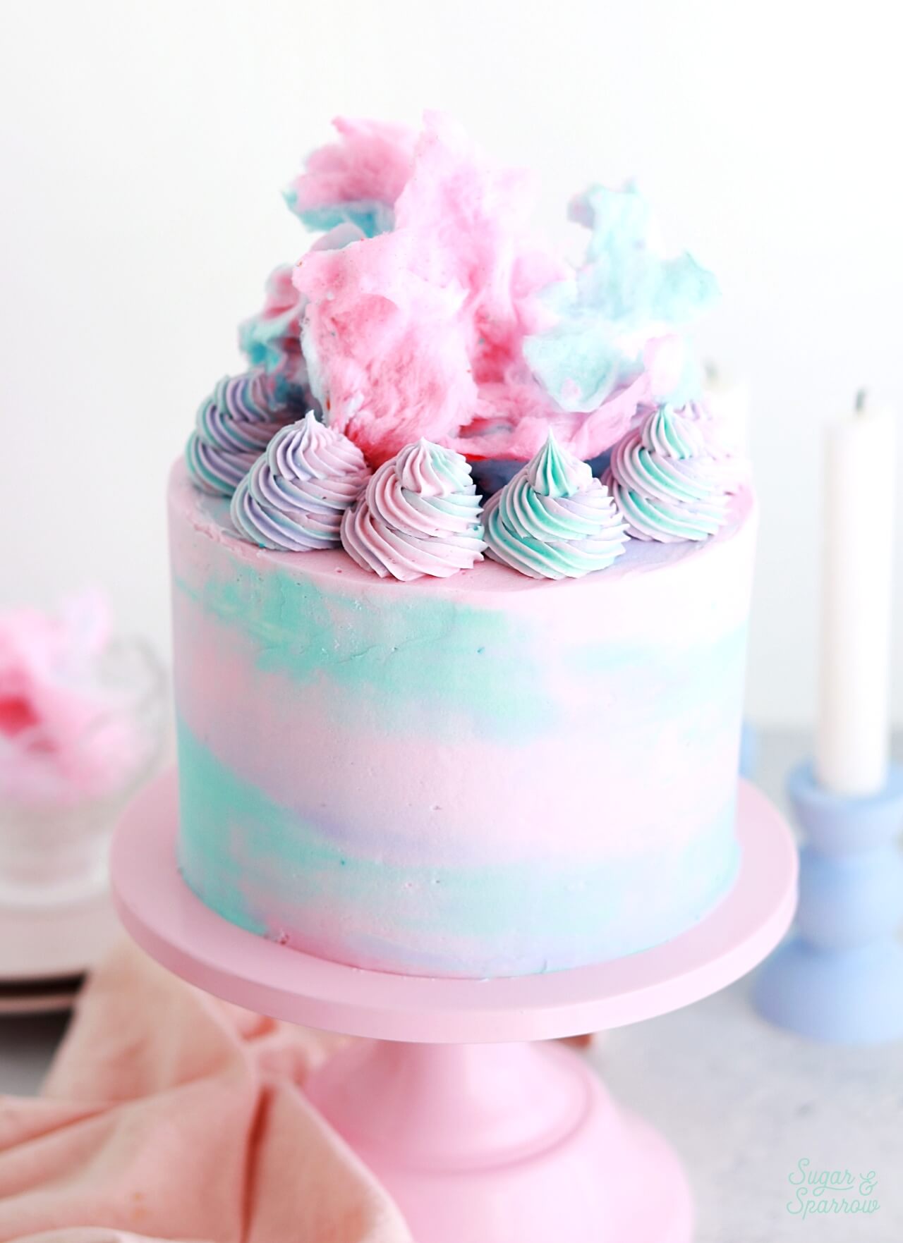 topping a cake with cotton candy