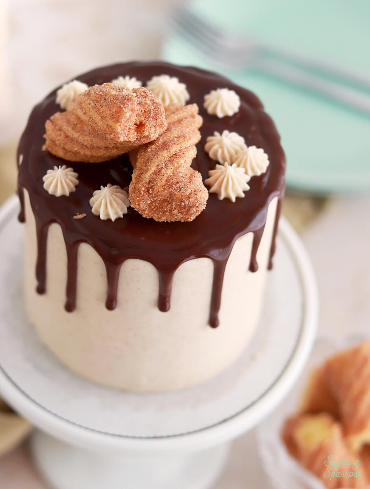 topping a cake with churros