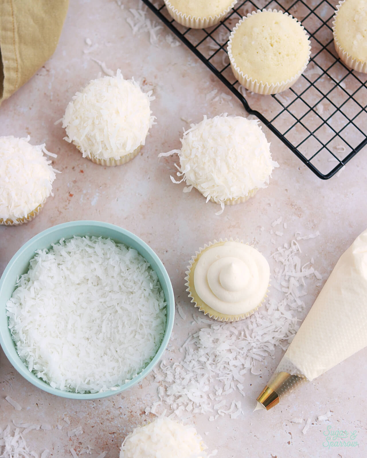 coconut cupcakes topped with coconut buttercream and shredded coconut