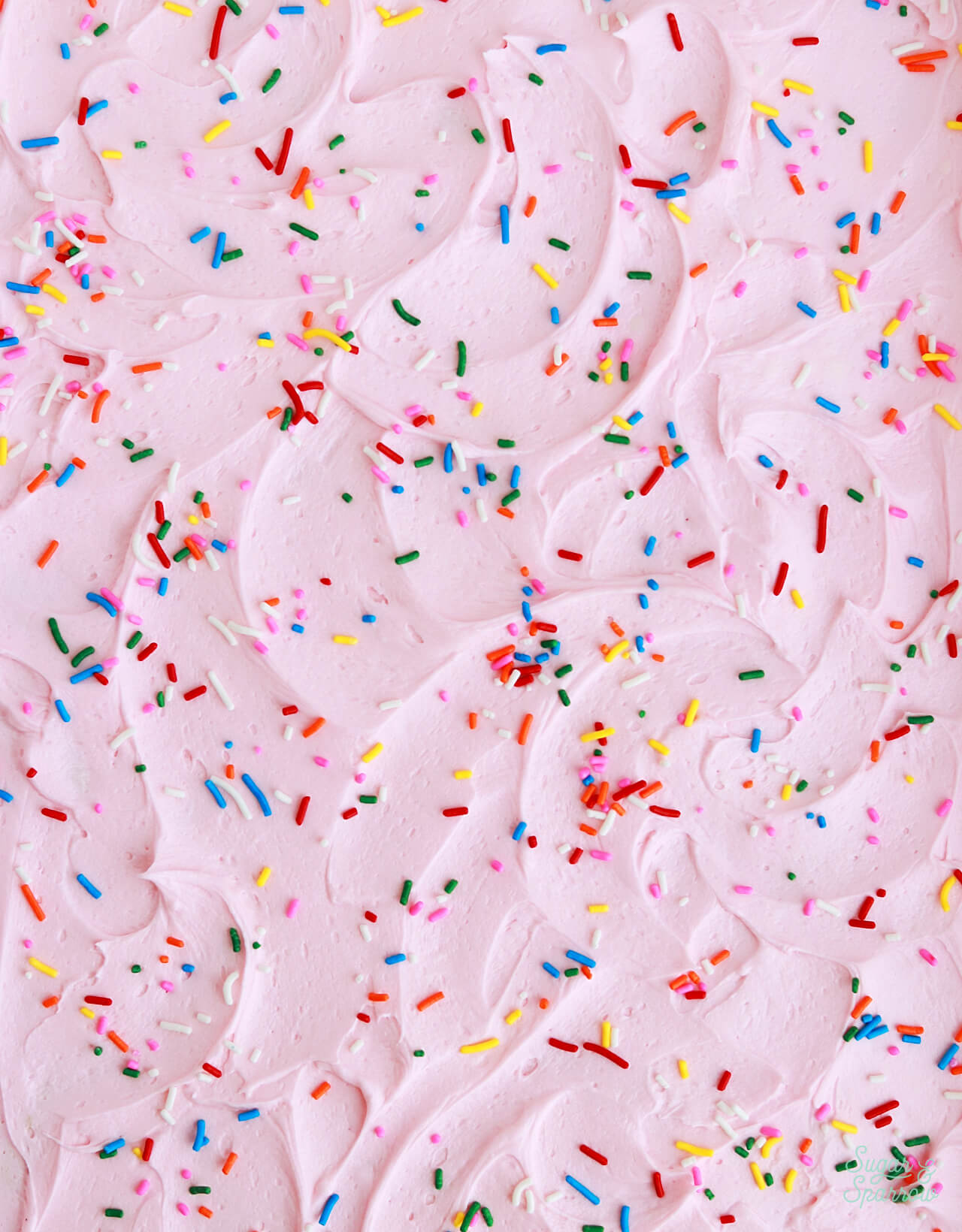 vanilla frosting with rainbow sprinkles