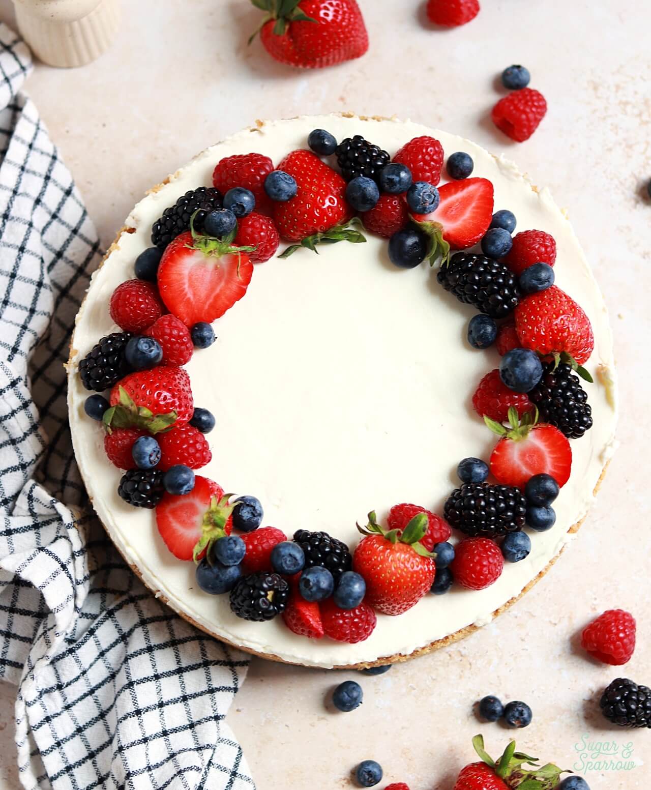 decorating a no bake cheesecake with fresh berries