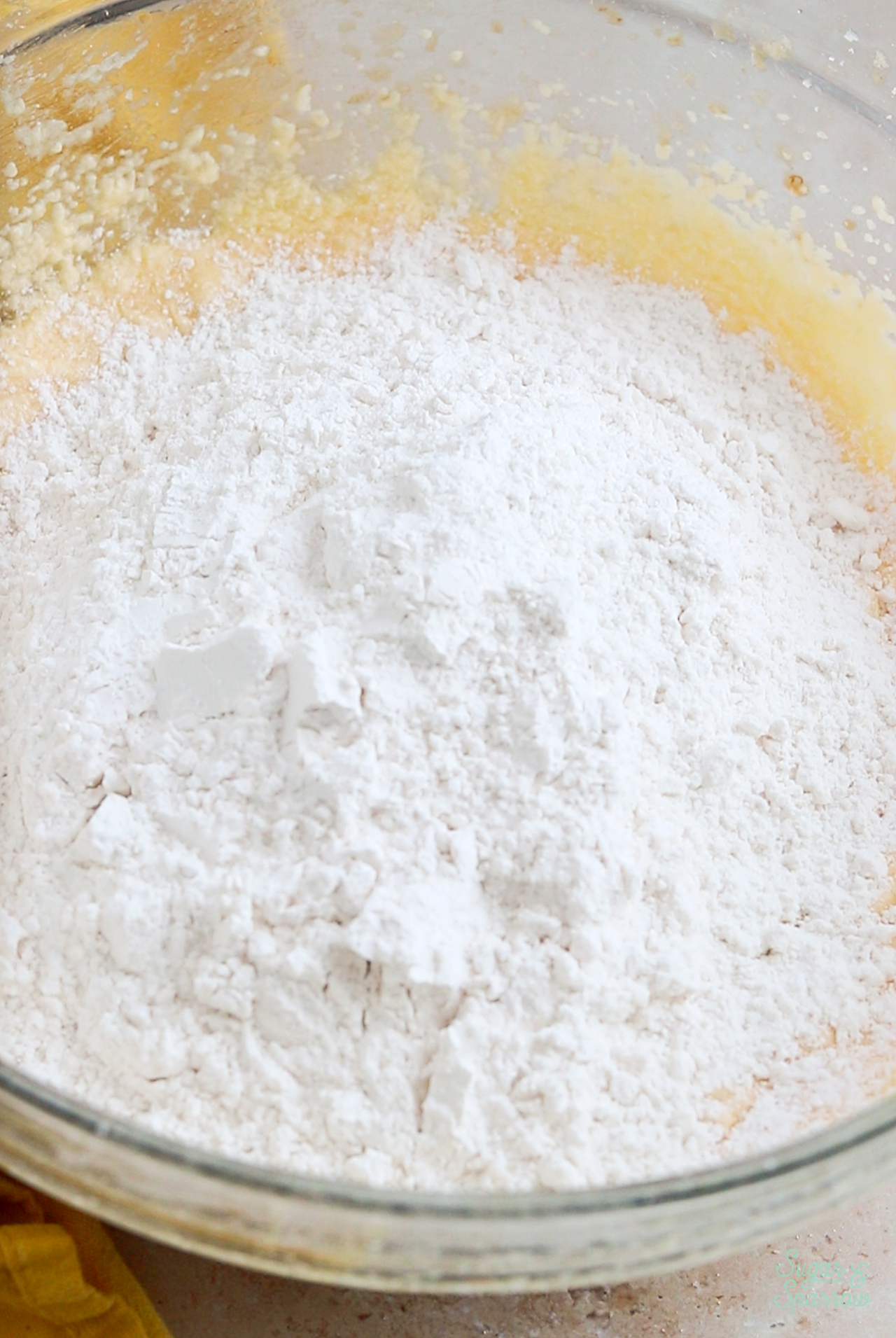 adding dry ingredients to cake batter