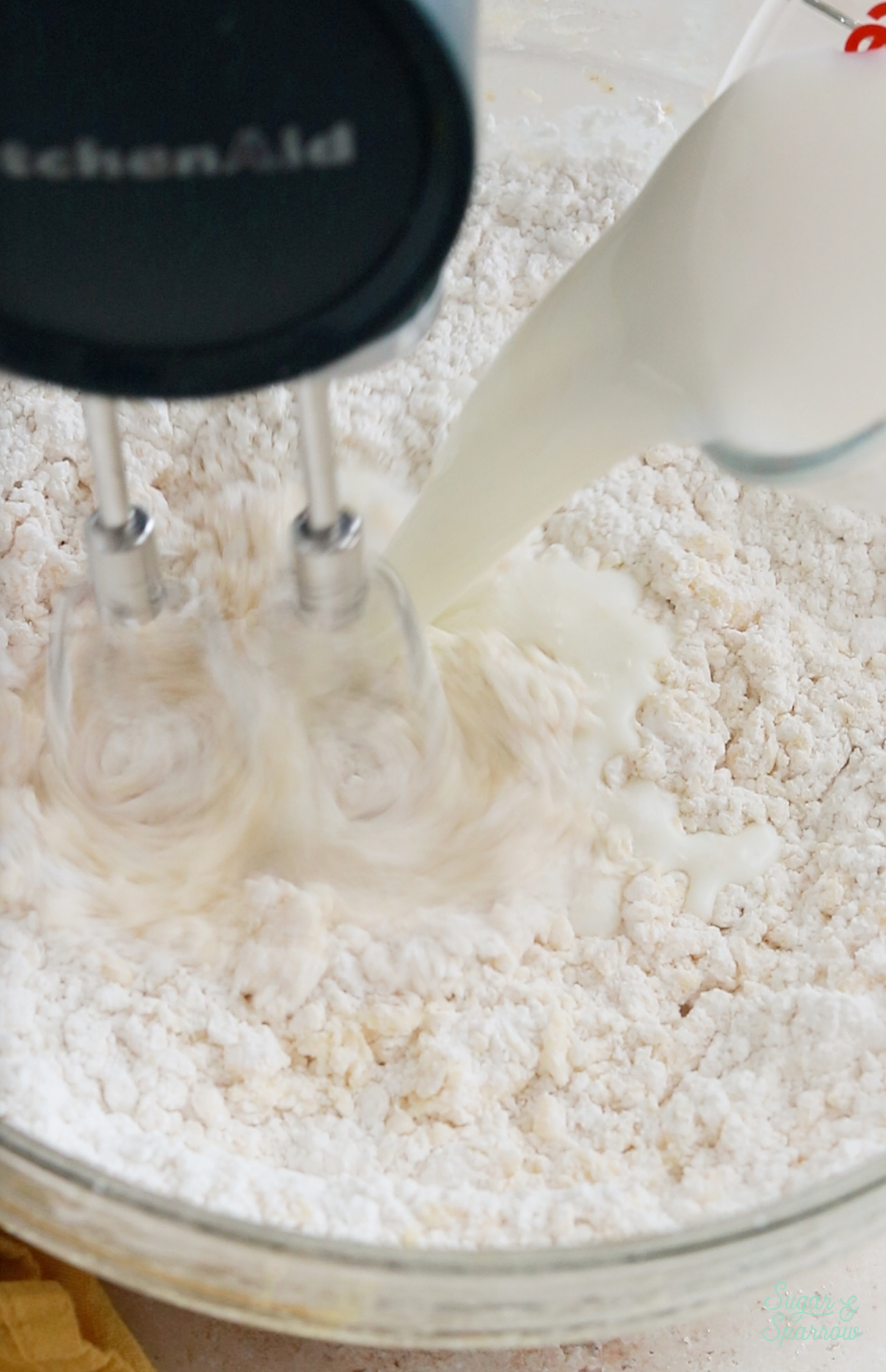 adding milk to cake batter