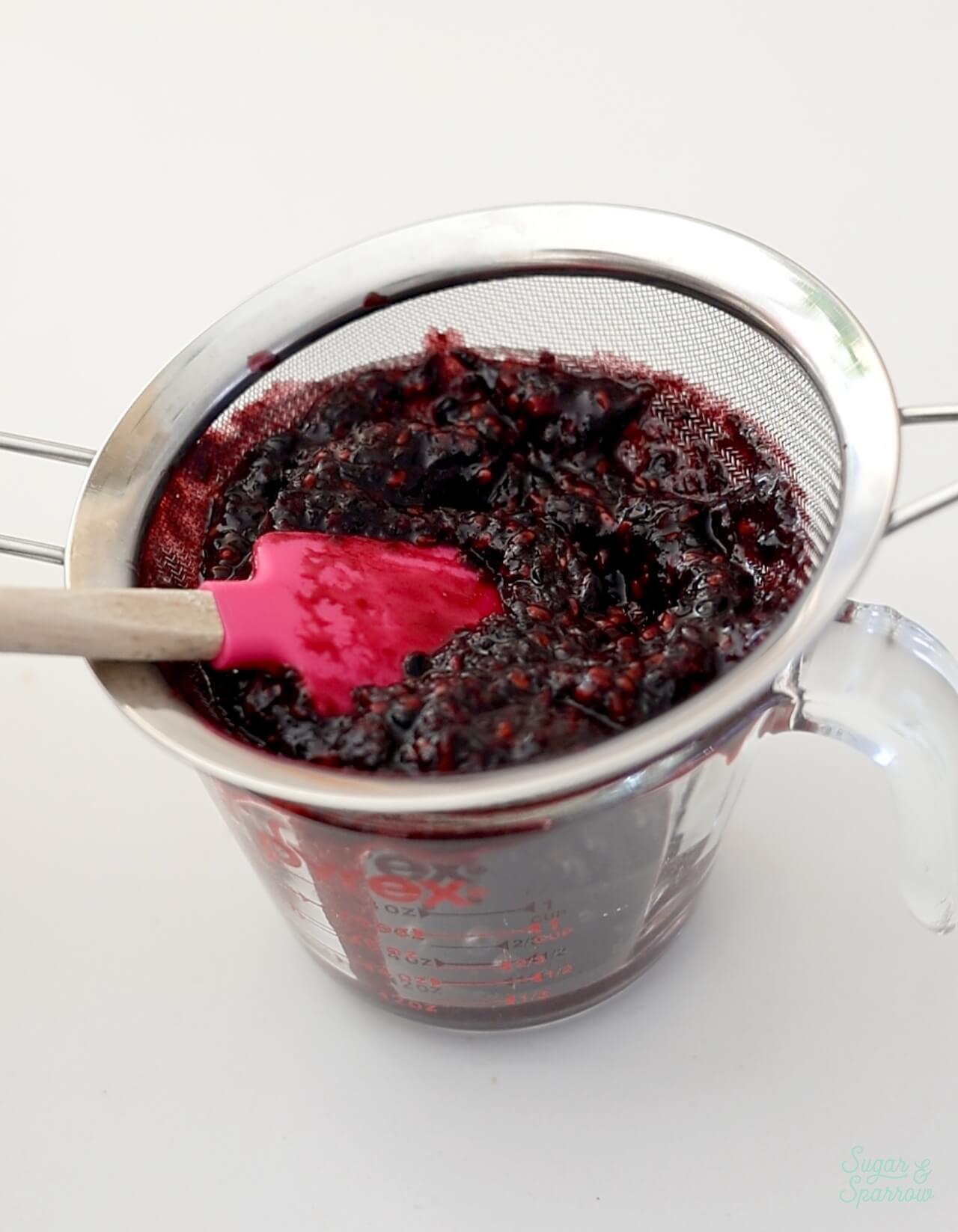 straining seeds out of blackberry puree