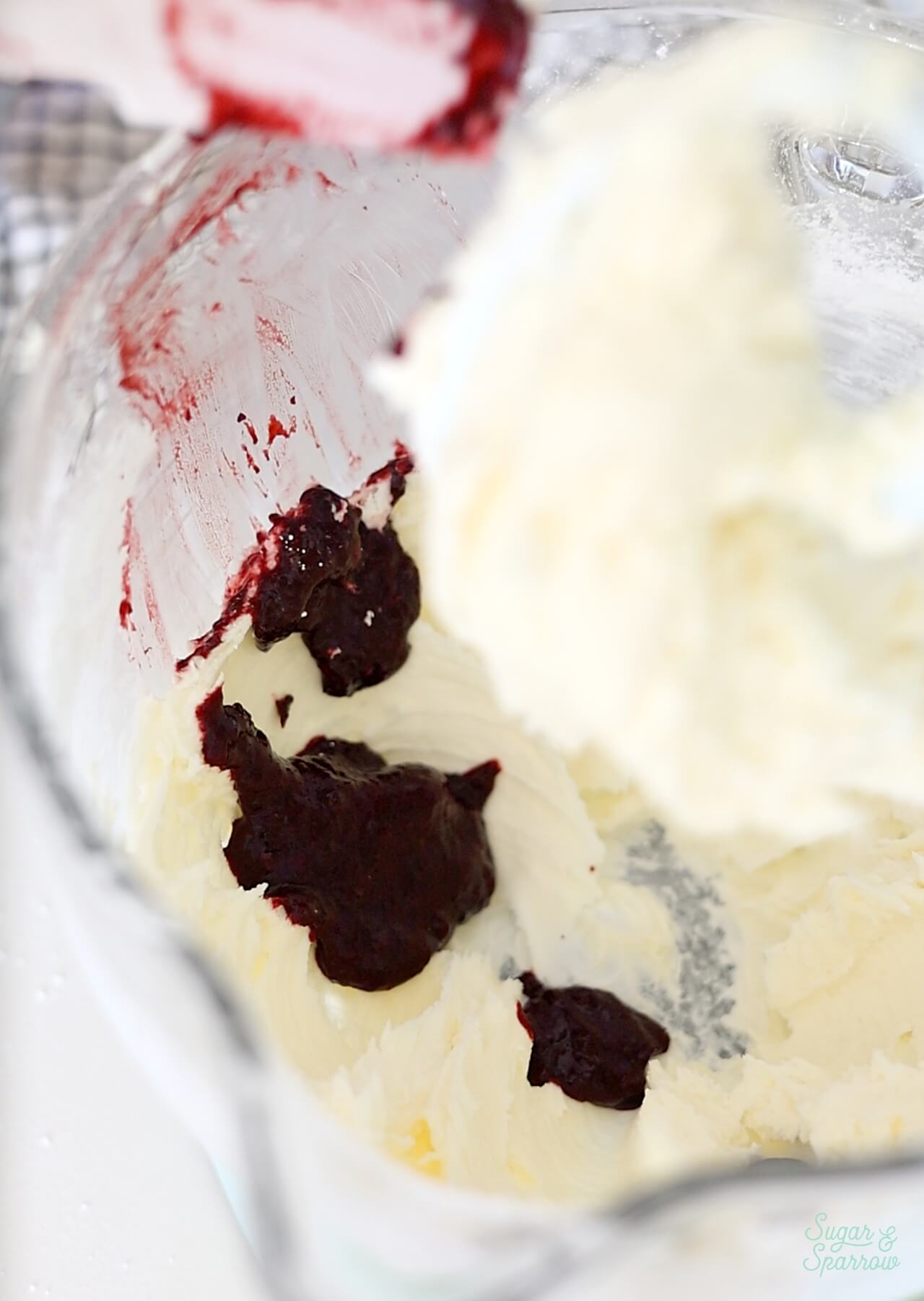 adding blackberry puree to buttercream