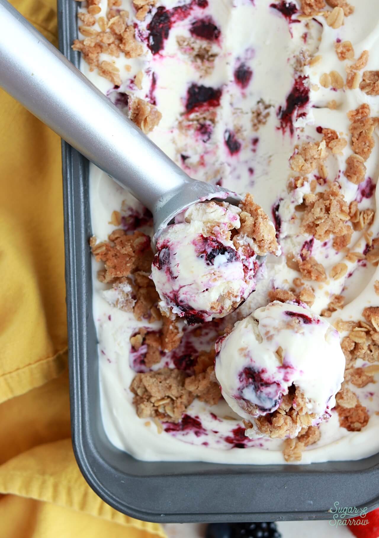 no-churn berry crisp ice cream scoops in a loaf pan