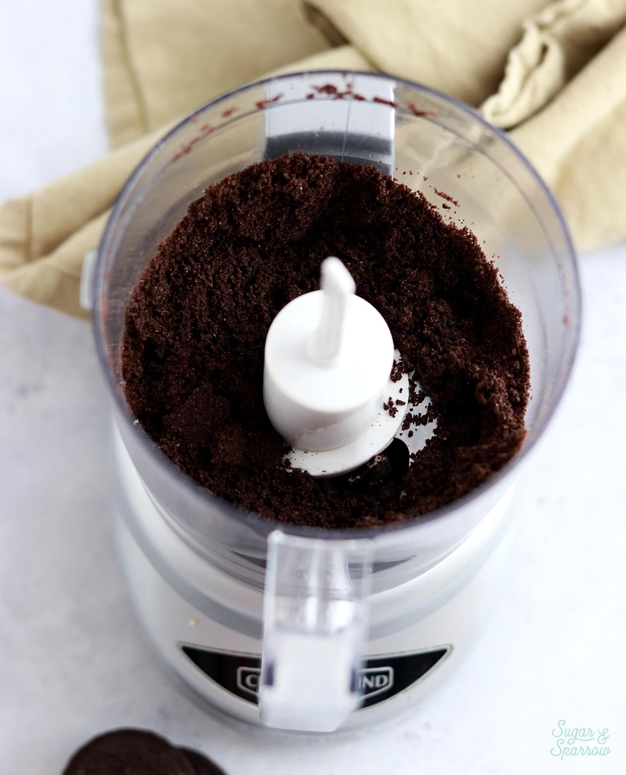 grinding oreos into crumbs using a food processor