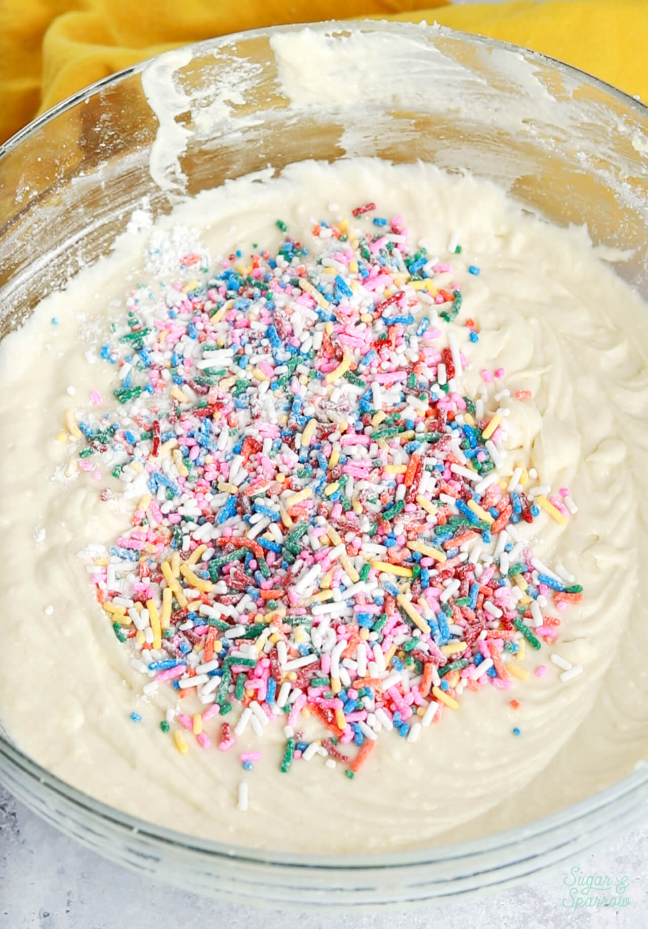 coating rainbow sprinkles in flour before adding them to cake batter