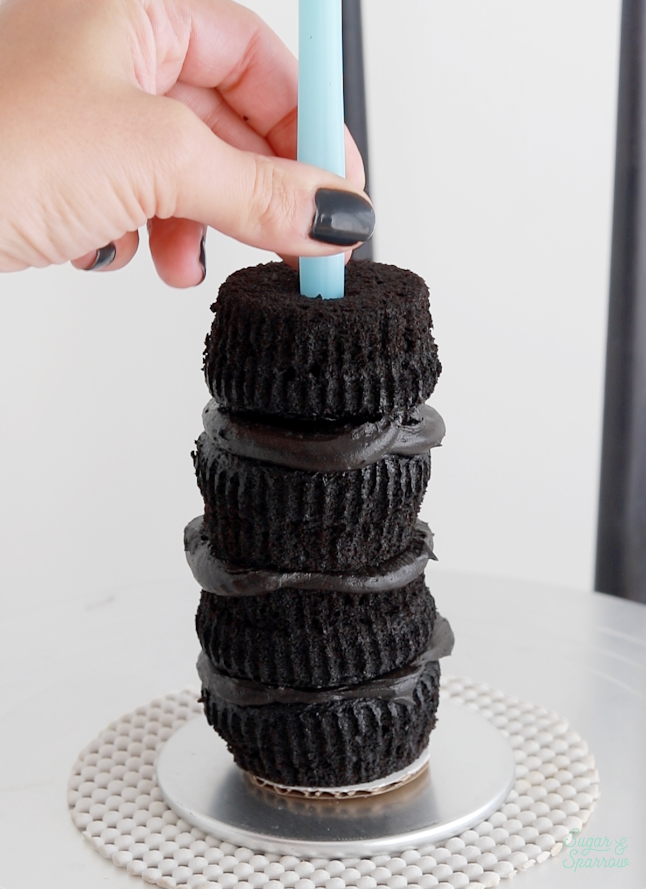 insert the boba straw into the middle of the cupcake tower