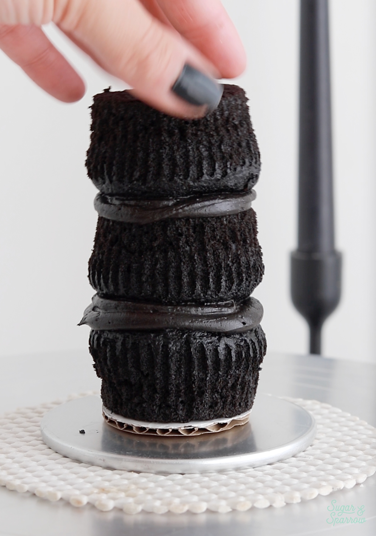 stack of three black velvet cupcakes