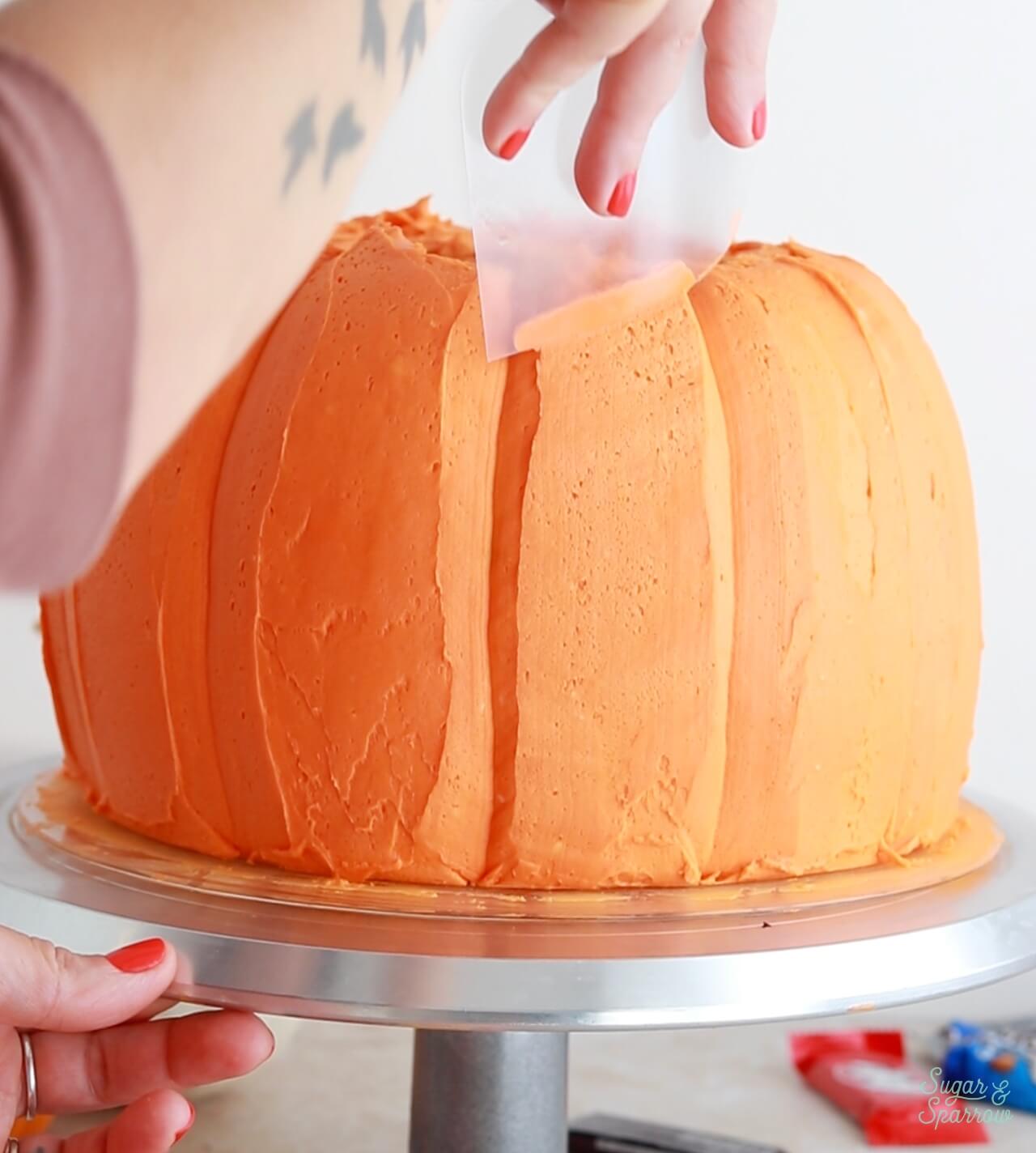 shaping a pumpkin cake