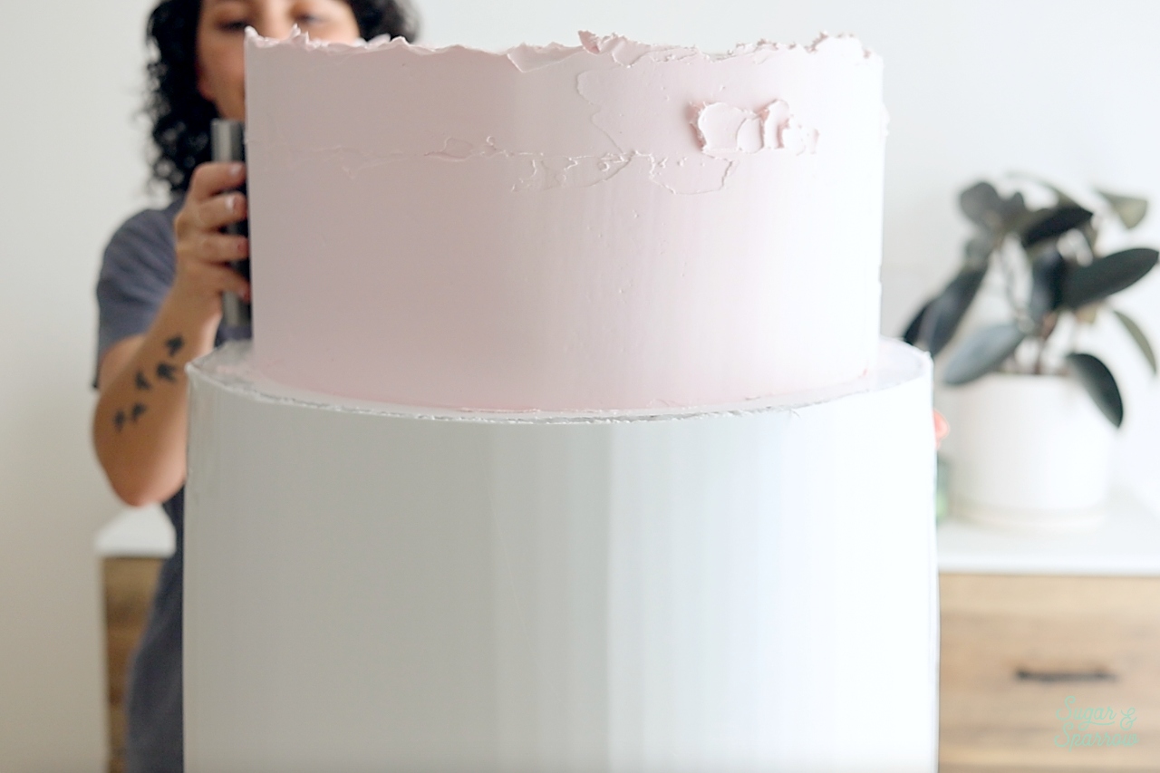 frosting a fake cake with spackle