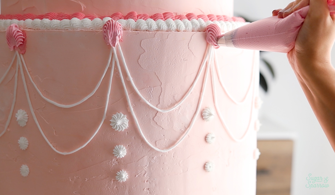 piping with spackle on a fake cake