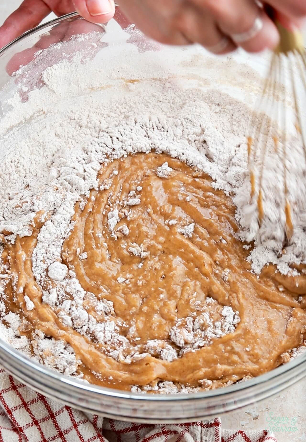 whisking dry ingredients into wet for pumpkin cake