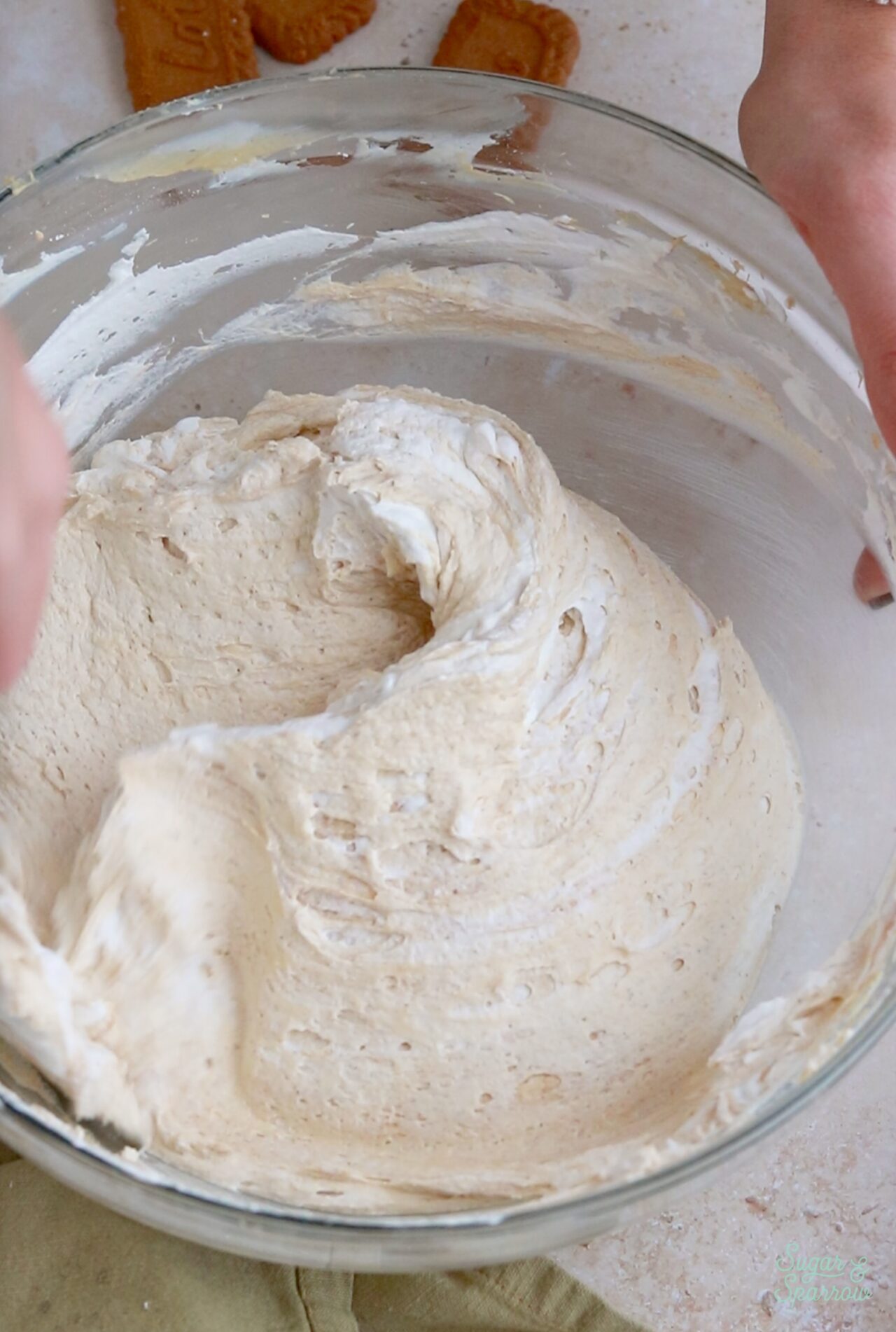 folding whipped cream into no-bake biscoff cheesecake filling