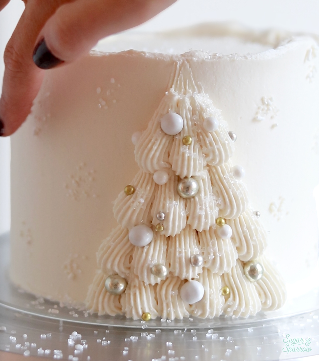 adding sprinkles onto a cake with fingertip