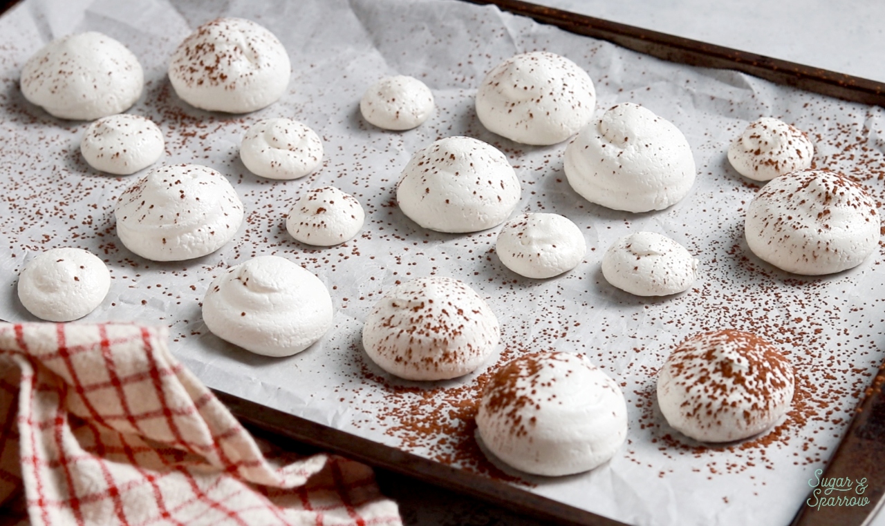 dusting meringue mushrooms with cocoa powder