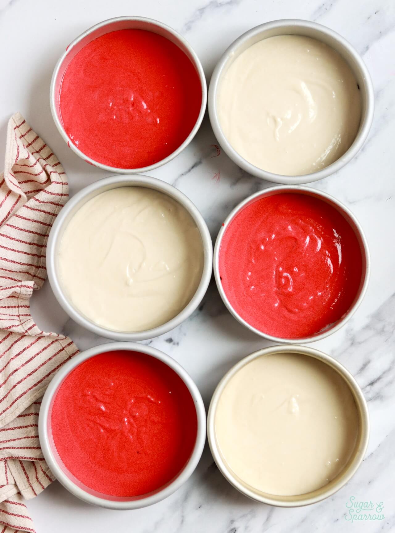 red and white cake batter in pans