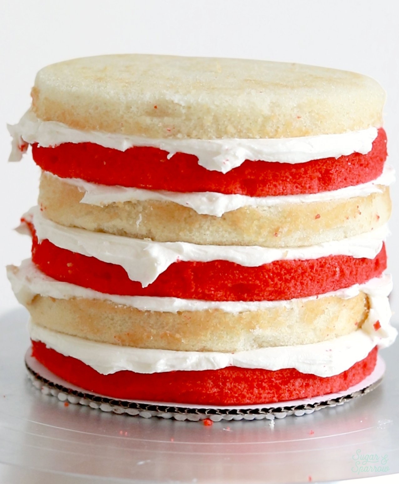filling and stacking candy cane cake layers