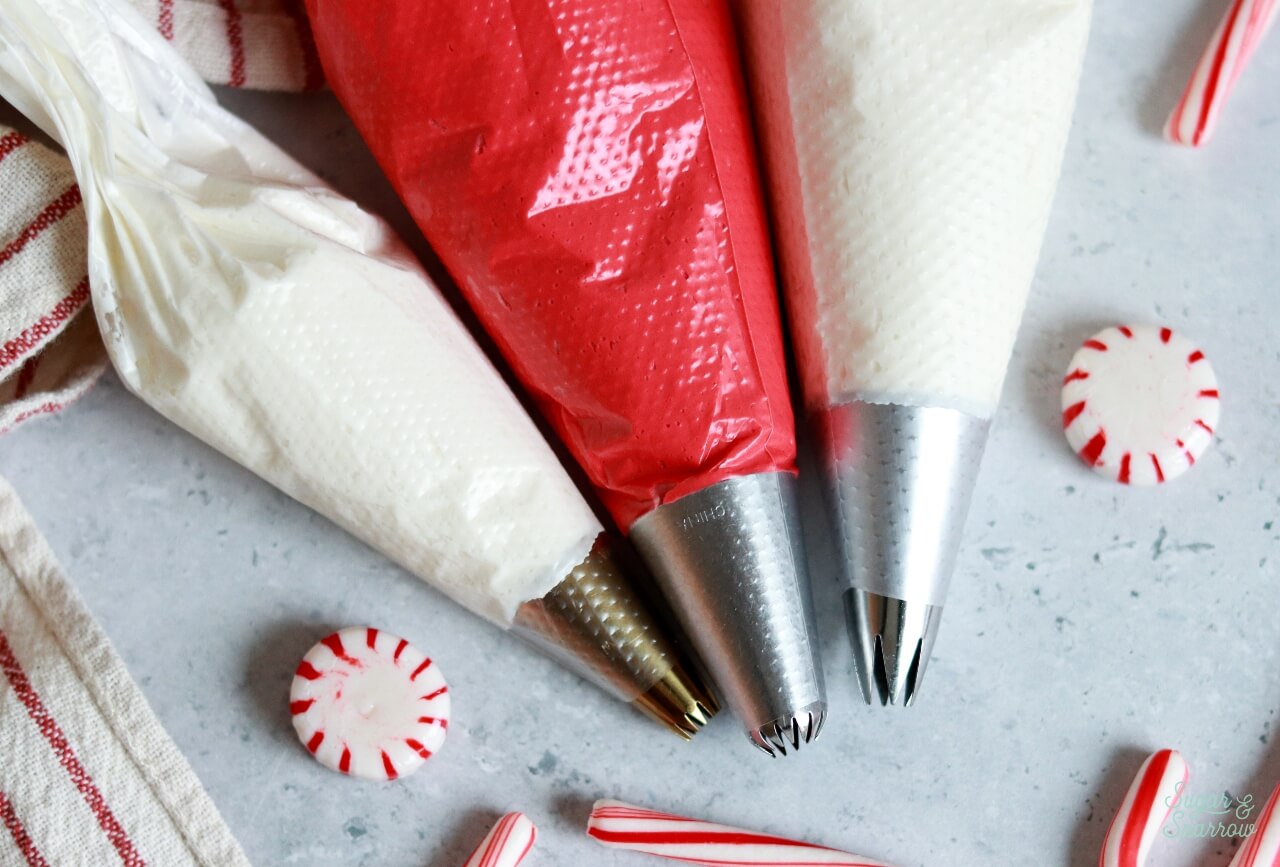 red and white buttercream in piping bags