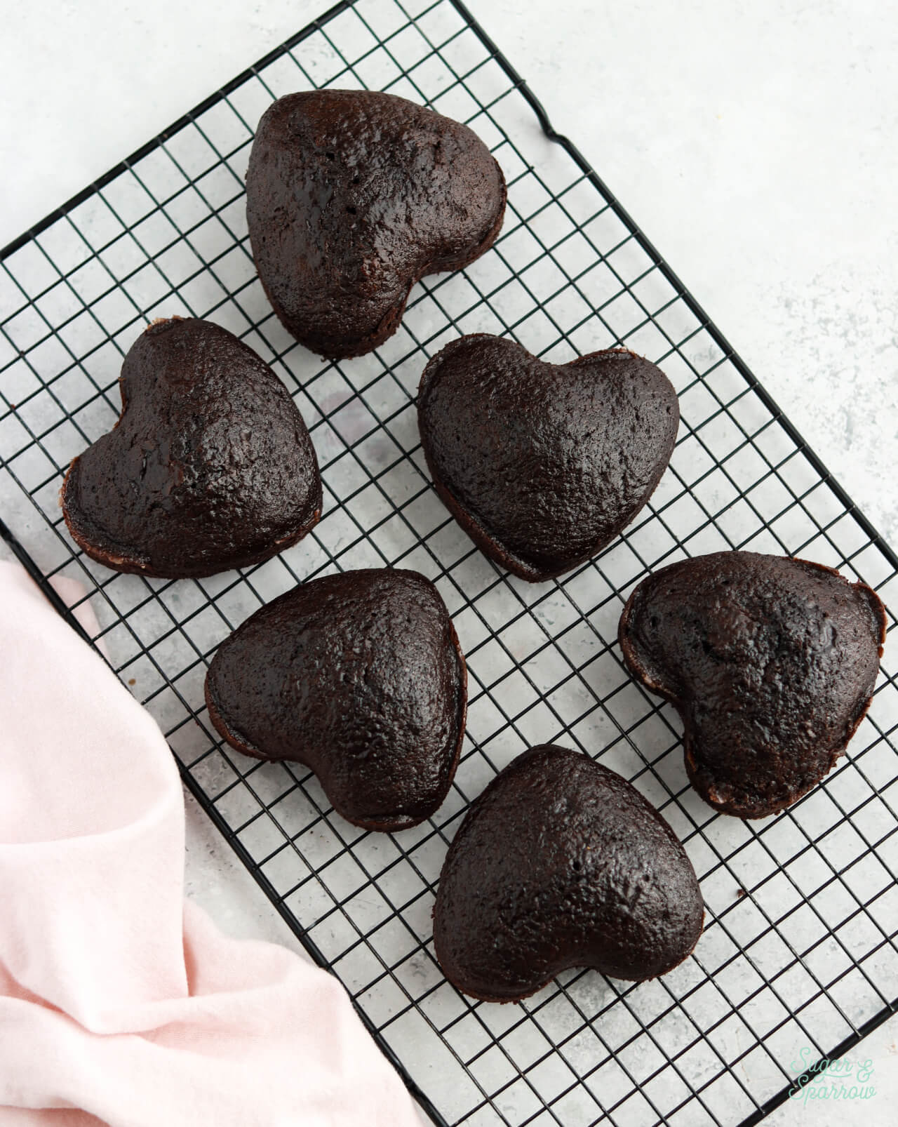 4-inch heart shaped cakes on a cooling rack