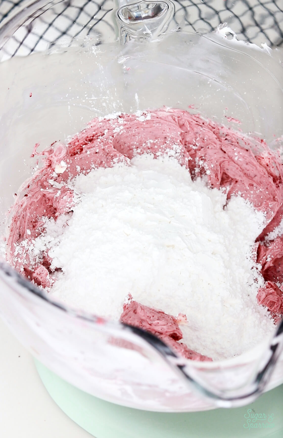 adding powdered sugar to cherry buttercream