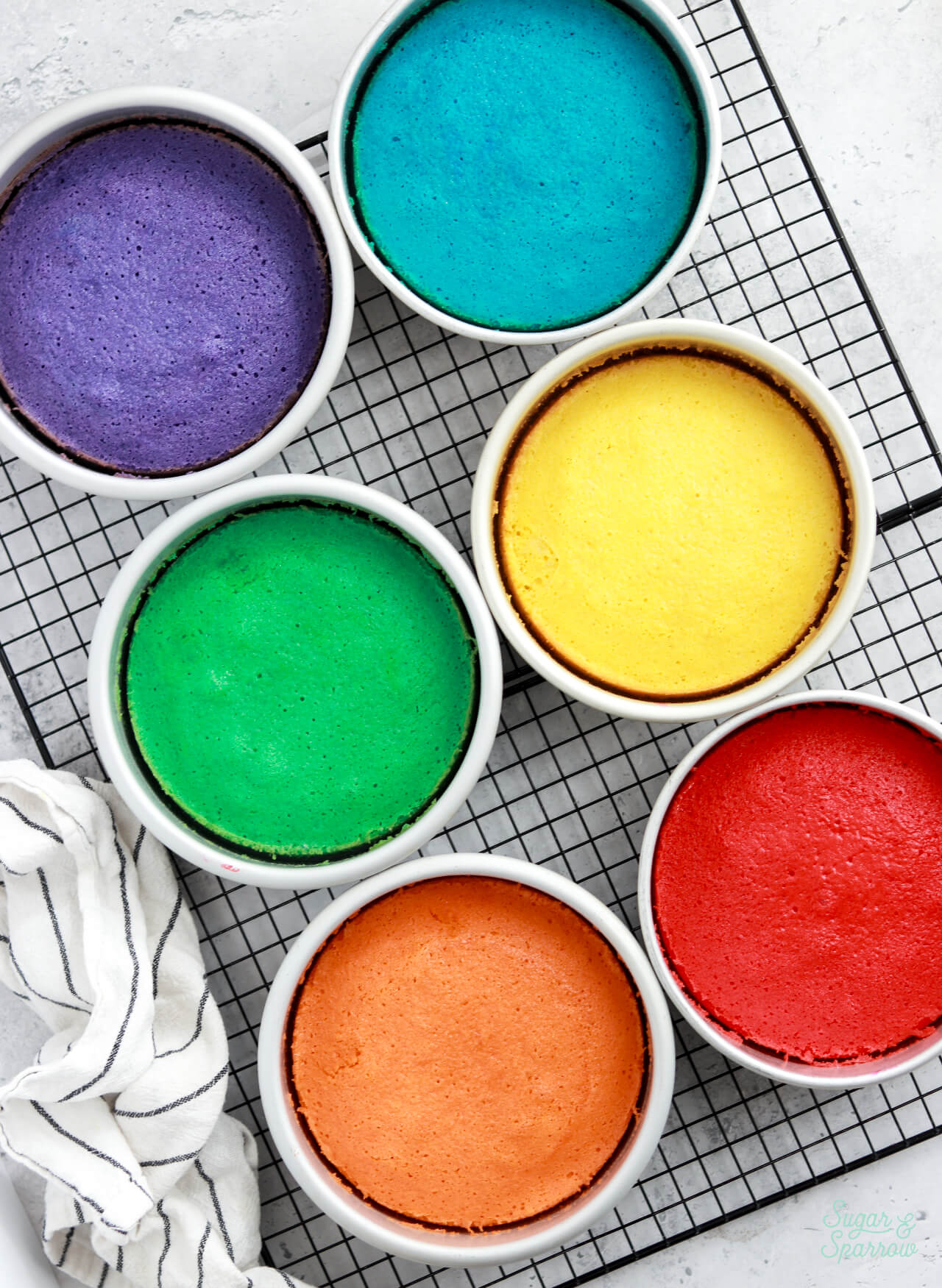 rainbow colored cake layers in pans