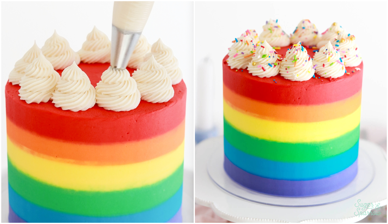 rainbow cake with white swirls on top and rainbow sprinkles