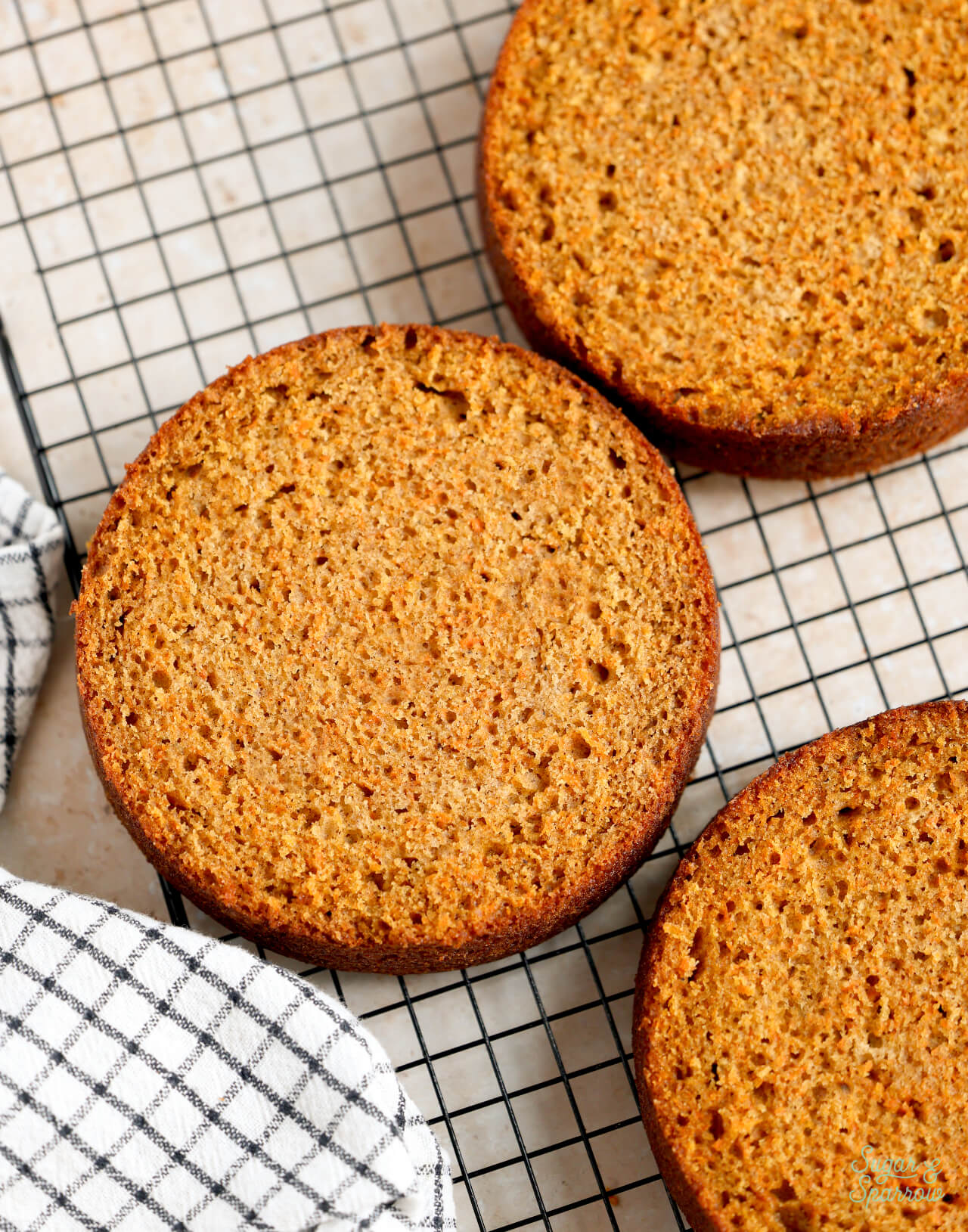 carrot cake layers cooling on a rack