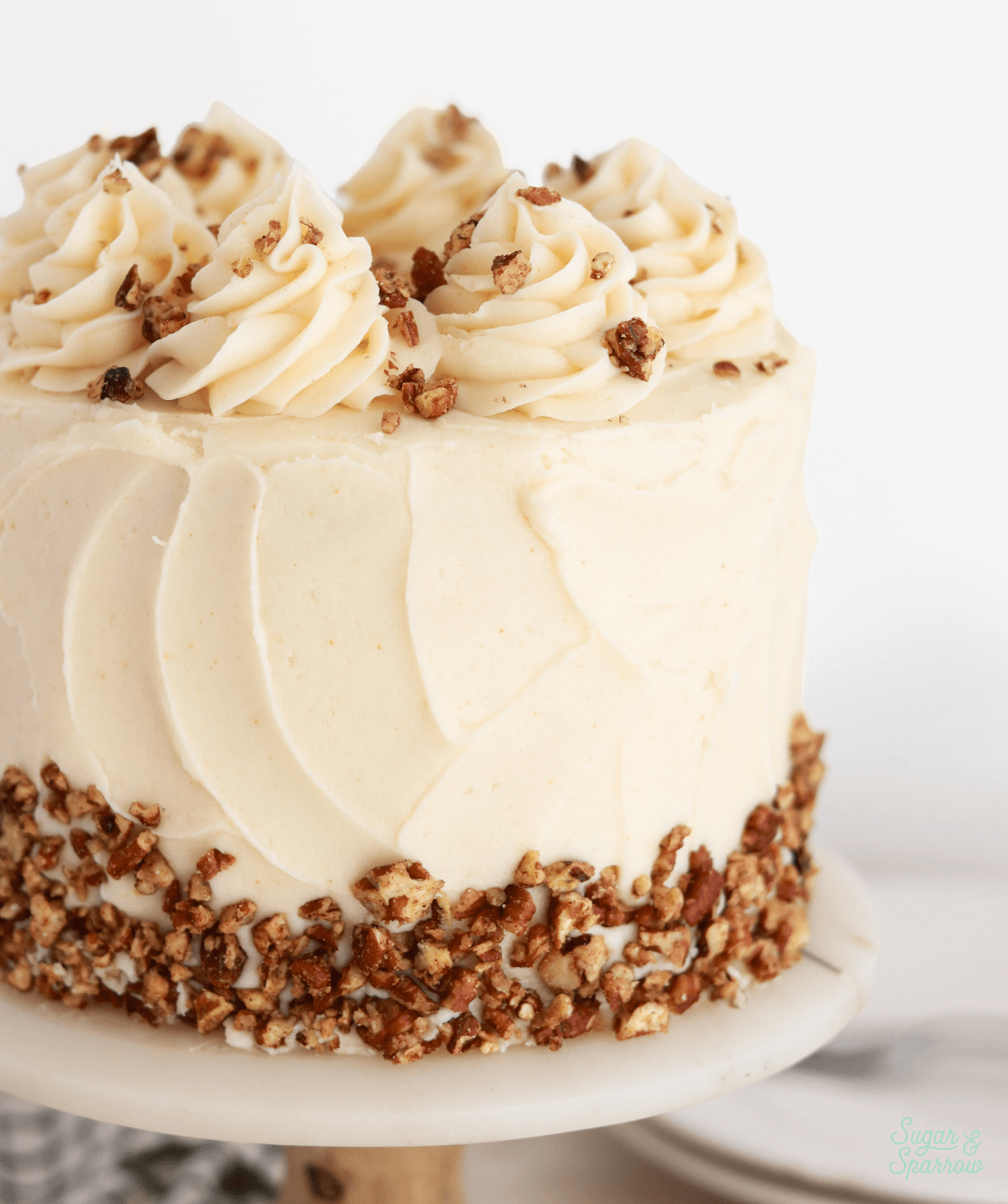 carrot cake with brown butter frosting and candied pecans
