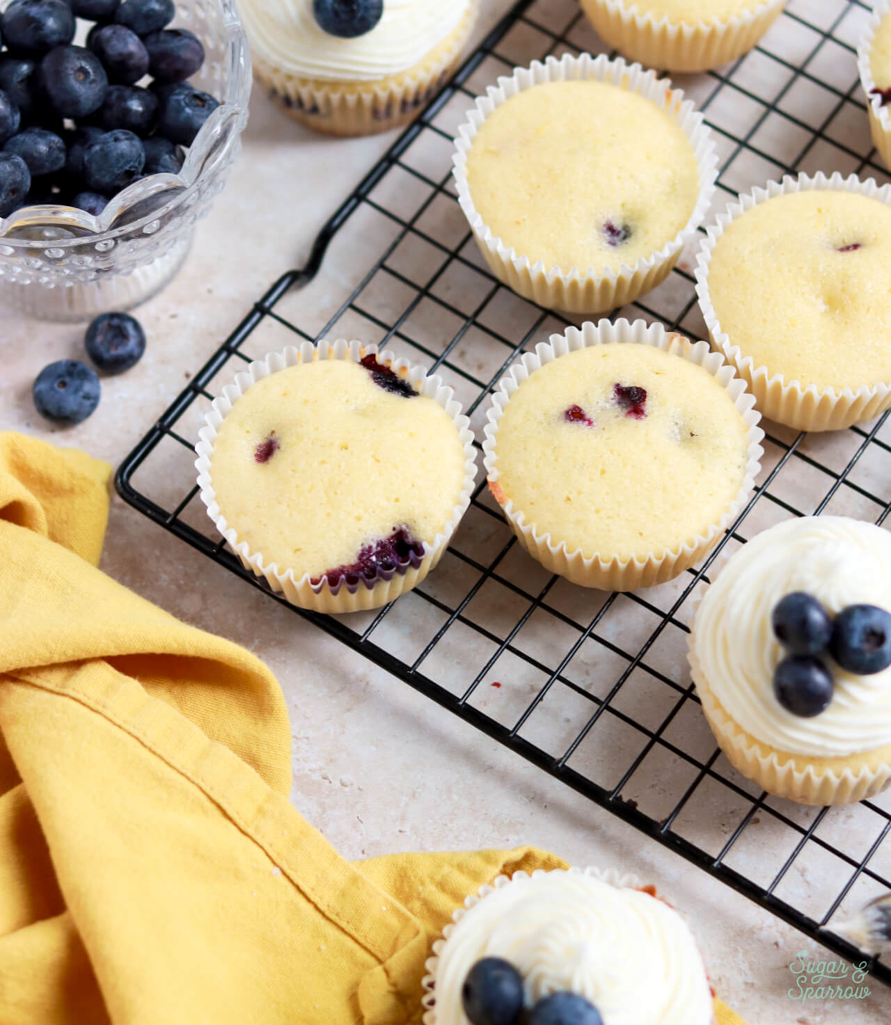 lemon blueberry cupcakes decorated with lemon cream cheese buttercream