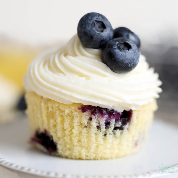 lemon blueberry cupcakes with lemon cream cheese frosting on a cupcake stand