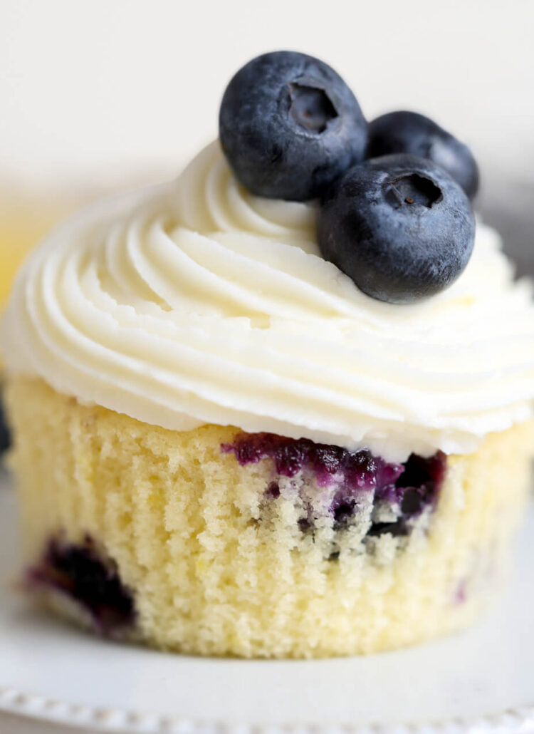 lemon blueberry cupcakes with lemon cream cheese frosting on a cupcake stand