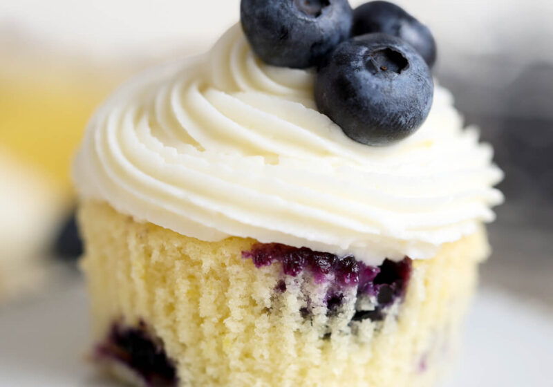 lemon blueberry cupcakes with lemon cream cheese frosting on a cupcake stand