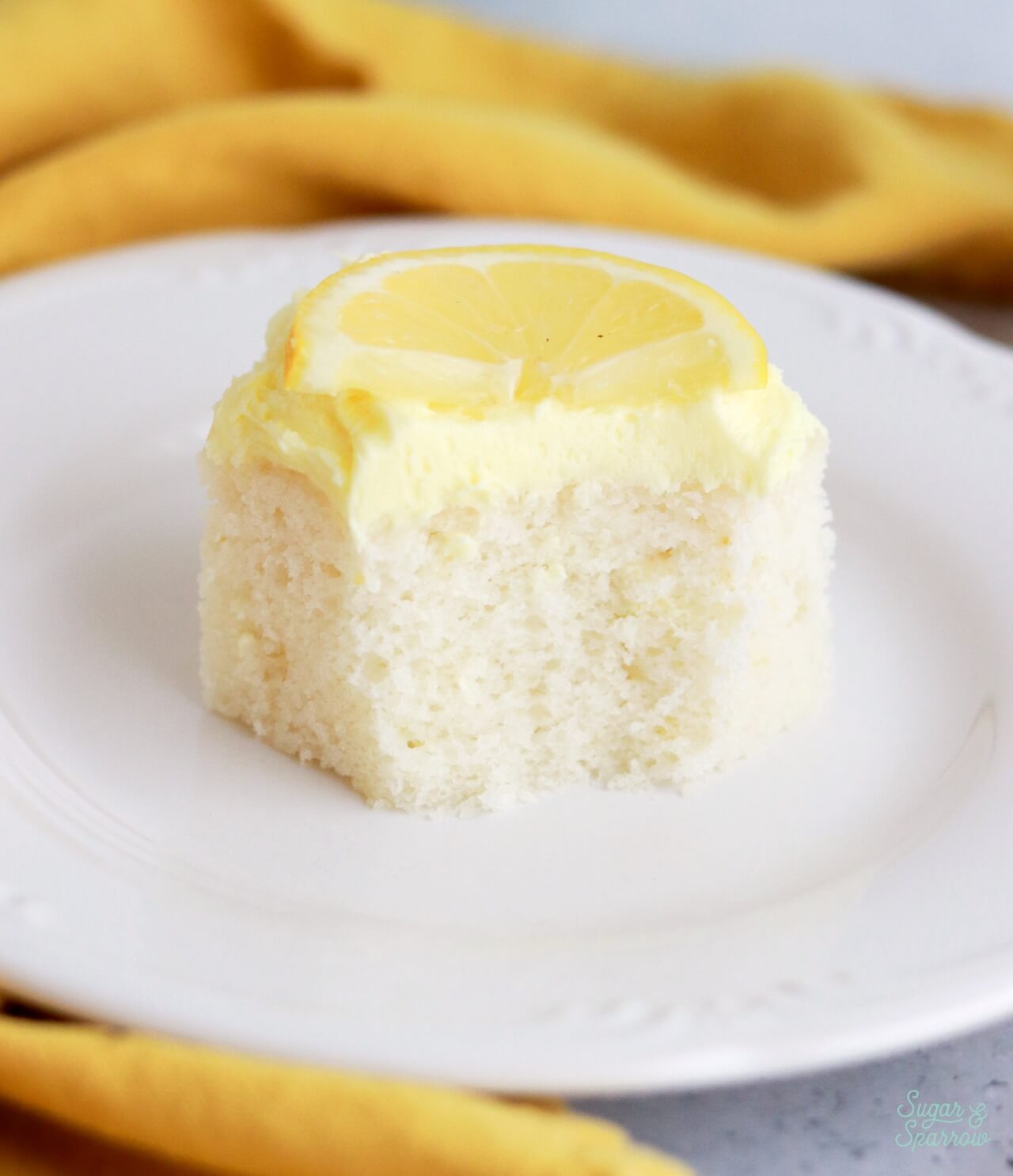 fluffy moist lemon sheet cake slice on plate