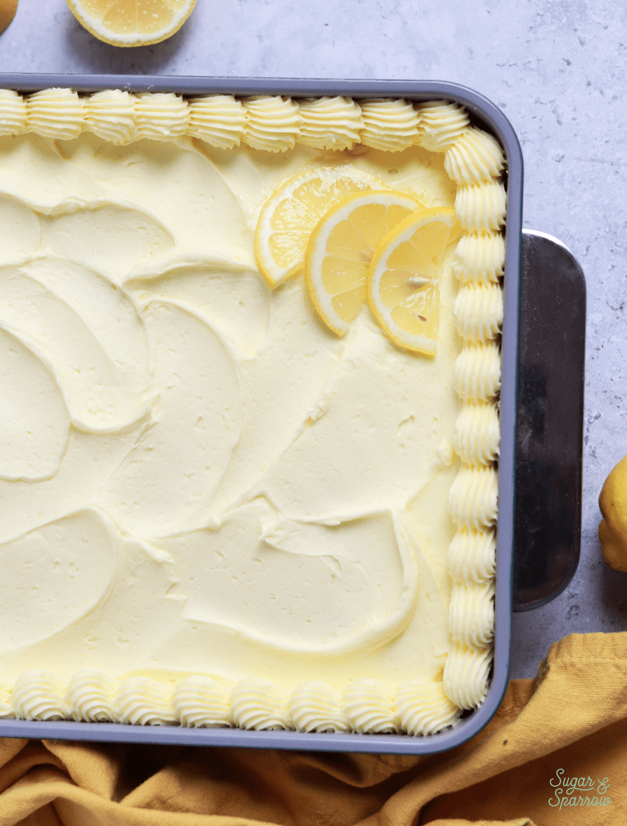 lemon sheet cake decorated in the pan
