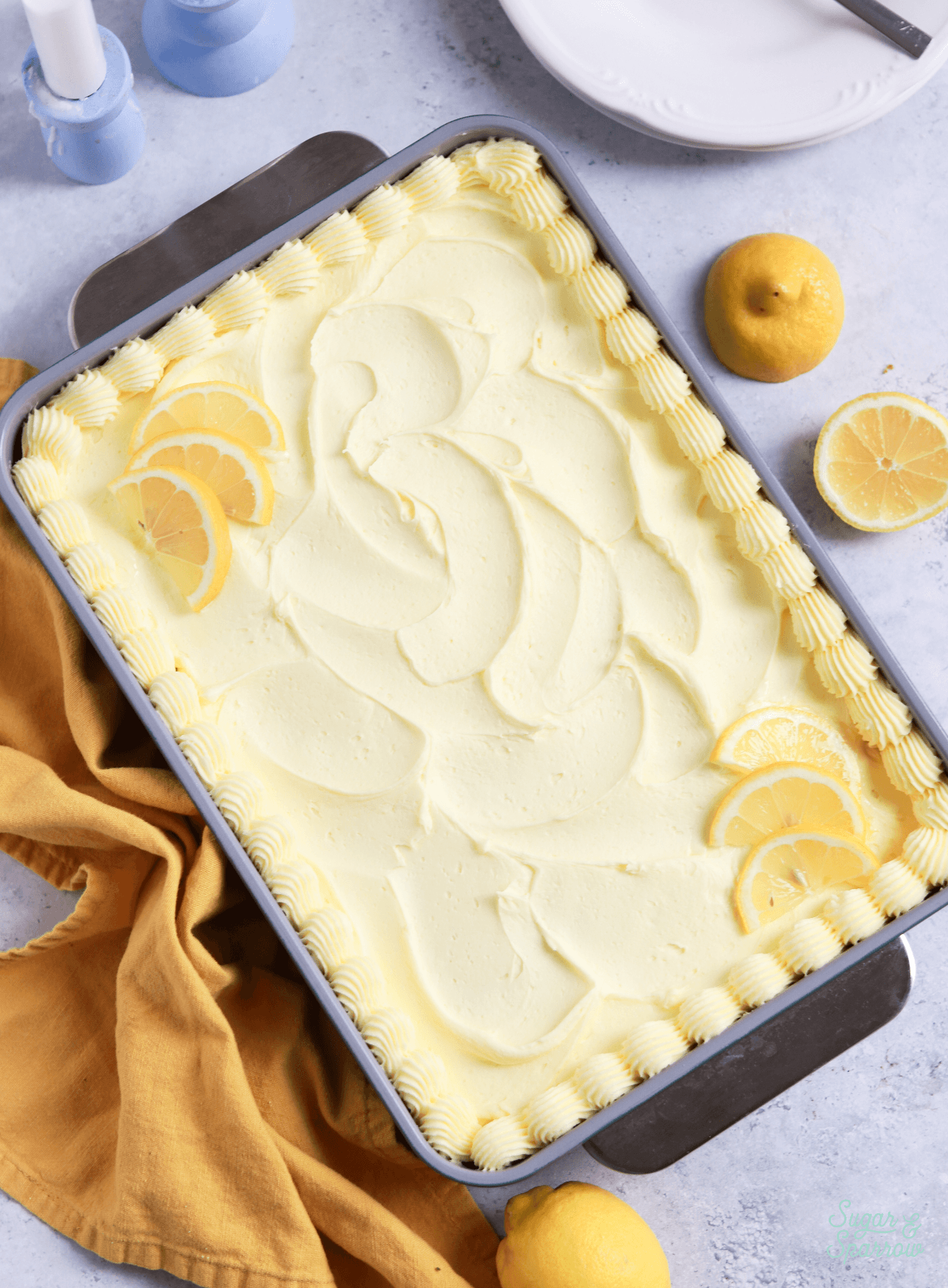 lemon cake baked in 9x13 cake pan and topped with lemon buttercream