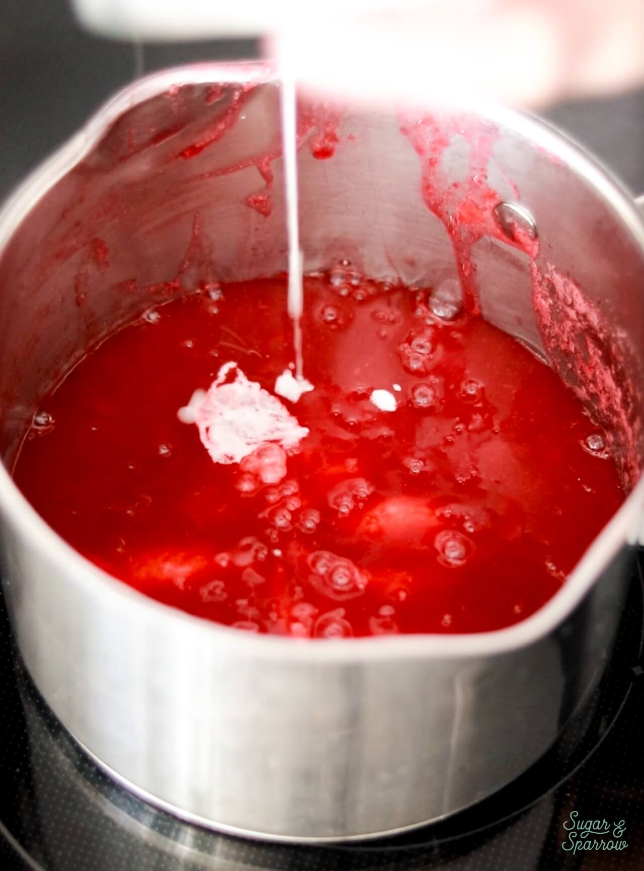 Adding cornstarch slurry to thicken raspberry filling