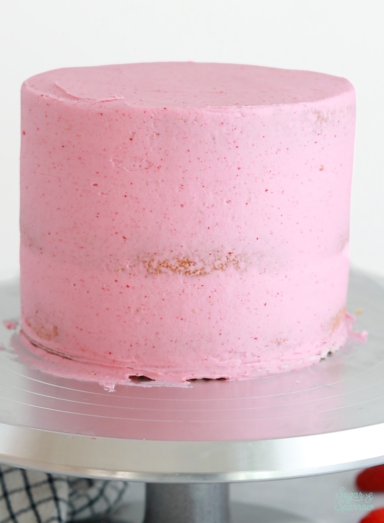 crumb coated cake with raspberry buttercream
